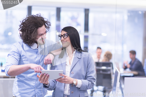 Image of Business People Working With Tablet in startup office