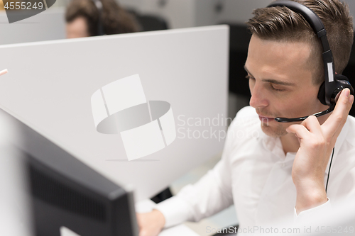 Image of male call centre operator doing his job