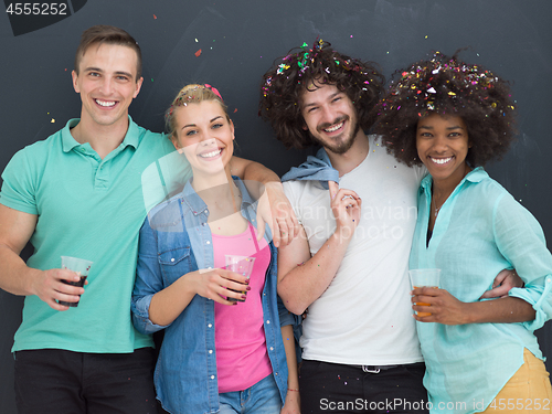 Image of confetti party multiethnic group of people isolated over gray