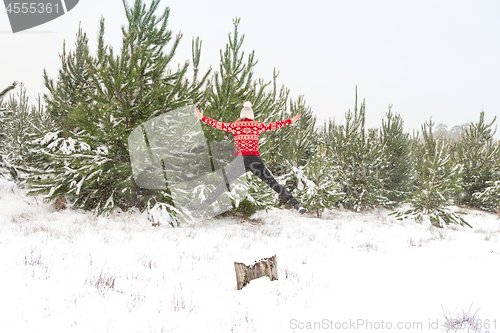 Image of Leap into Life  Woman jumping high in a snowy landscape