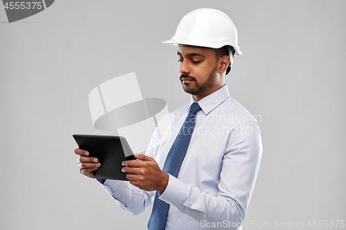 Image of architect or businessman in helmet with tablet pc