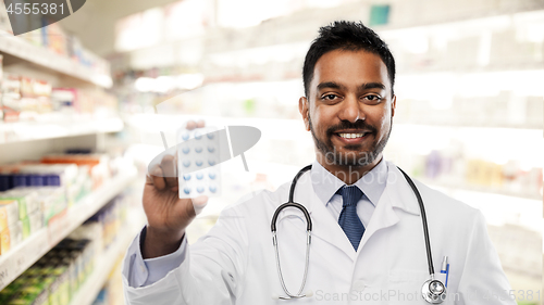 Image of indian male doctor or pharmacist with pills