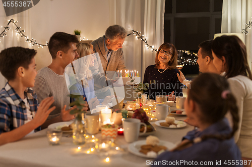 Image of happy family having birthday party at home