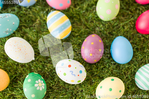 Image of colored easter eggs on artificial grass