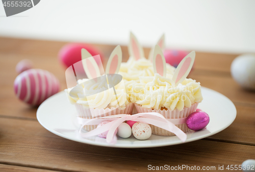 Image of cupcakes with easter eggs and candies on table