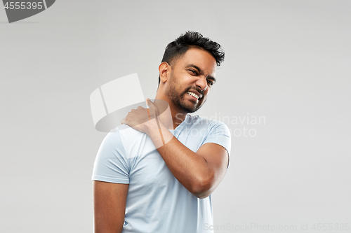 Image of unhealthy indian man suffering from neck pain