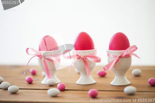 Image of easter eggs in holders and candy drops on table