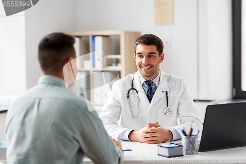 Image of doctor with laptop and male patient at hospital