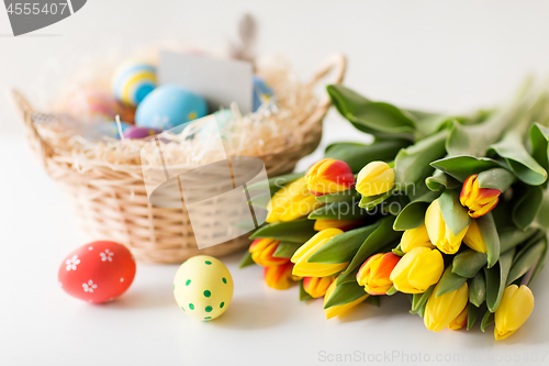 Image of close up of colored easter eggs and tulip flowers