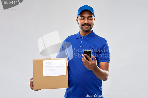 Image of indian delivery man with smartphone and parcel box