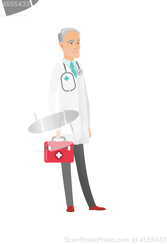 Image of Senior caucasian doctor holding first aid box.