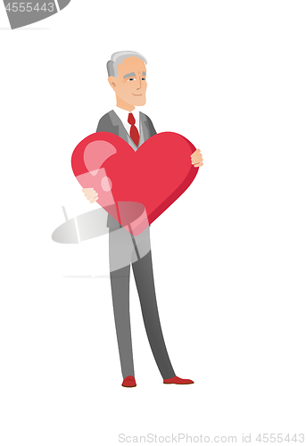 Image of Caucasian businessman holding a big red heart.