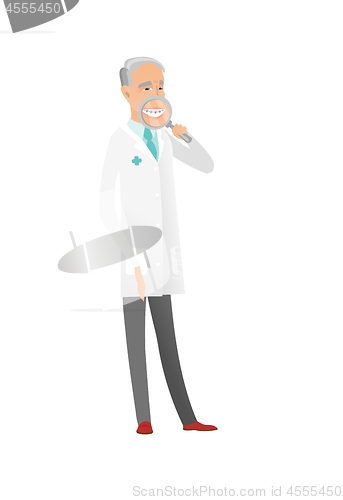 Image of Caucasian dentist examining teeth with a magnifier
