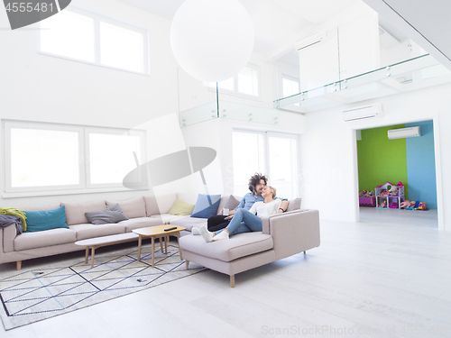 Image of Young couple on the sofa watching television