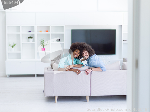 Image of young multiethnic couple in living room