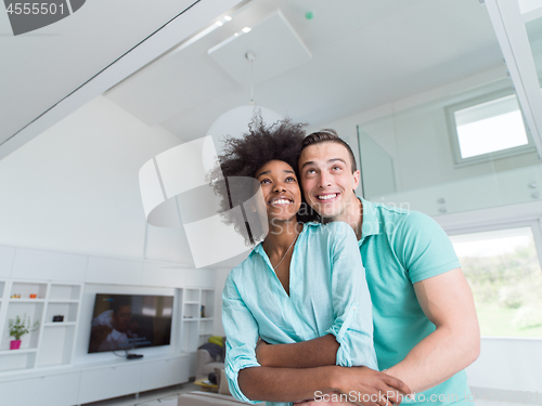 Image of multiethnic couple hugging