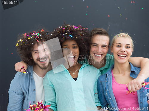 Image of confetti party multiethnic group of people isolated over gray