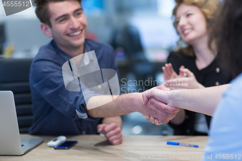 Image of cloasing the deal in modern office interior