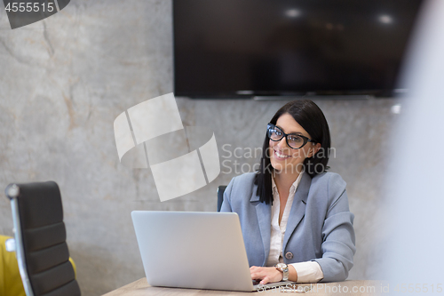 Image of businesswoman using a laptop in startup office