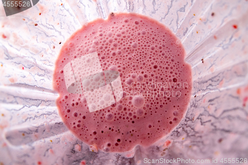 Image of Freshly made strawberries smoothie with chia seeds in blender cup, top view