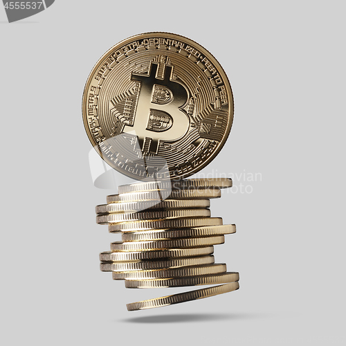 Image of Bitcoin is a gold coin and a stack of crypto-currencies