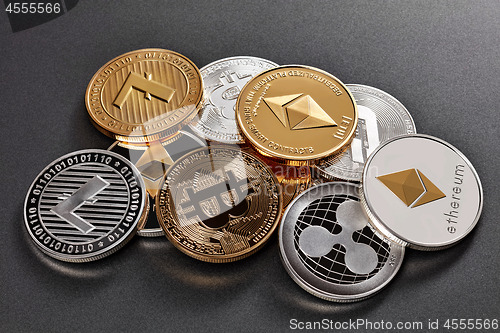 Image of Different coins of crypto currency on a dark background