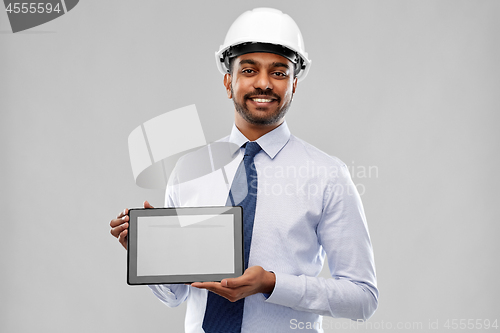 Image of architect or businessman in helmet with tablet pc