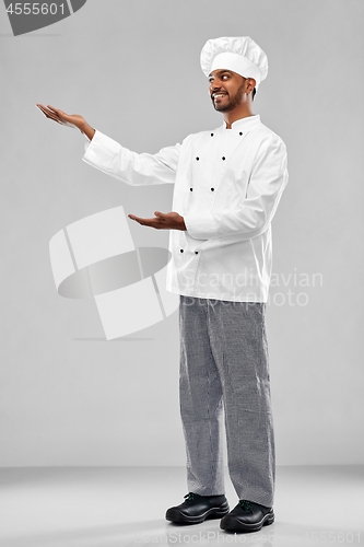 Image of happy male indian chef in toque