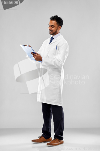 Image of smiling indian doctor or scientist with clipboard