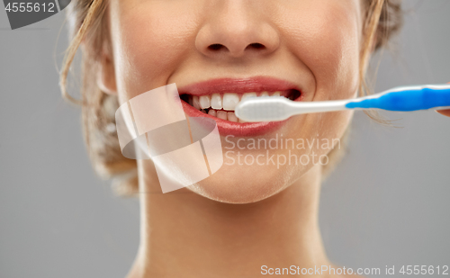 Image of close up of woman with toothbrush cleaning teeth