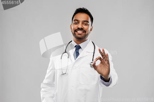 Image of smiling indian male doctor showing ok gesture