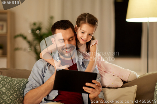 Image of father and daughter with tablet computer at home