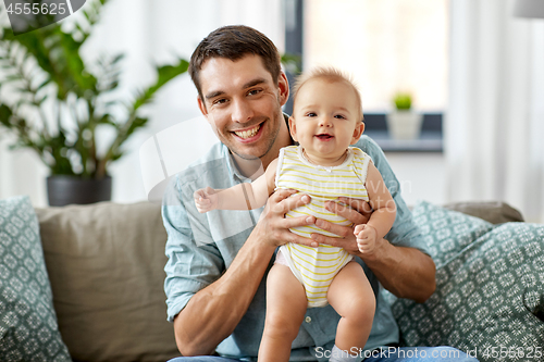 Image of father with little baby daughter at home