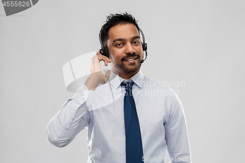 Image of indian businessman or helpline operator in headset