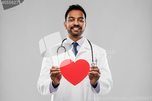 Image of smiling indian male doctor with red heart shape