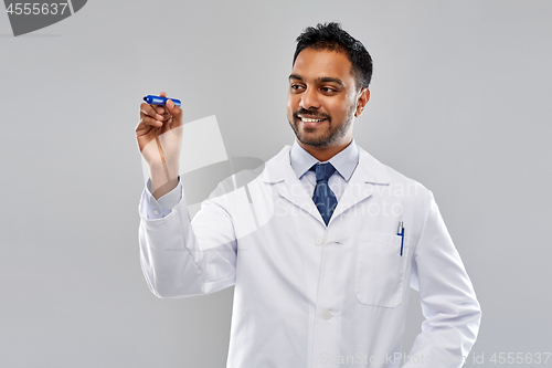 Image of indian male doctor or scientist with marker