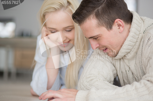 Image of Young Couple using digital tablet on cold winter day