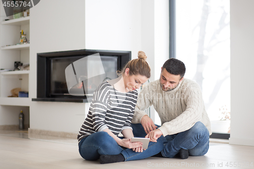 Image of Young Couple using digital tablet on cold winter day