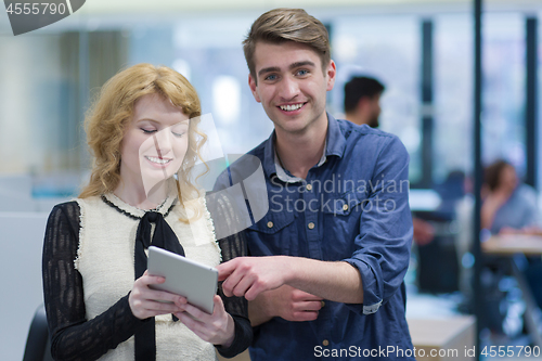 Image of Business People Working With Tablet in startup office