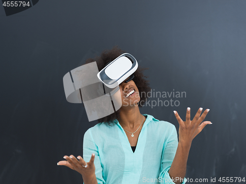 Image of black girl using VR headset isolated on gray background