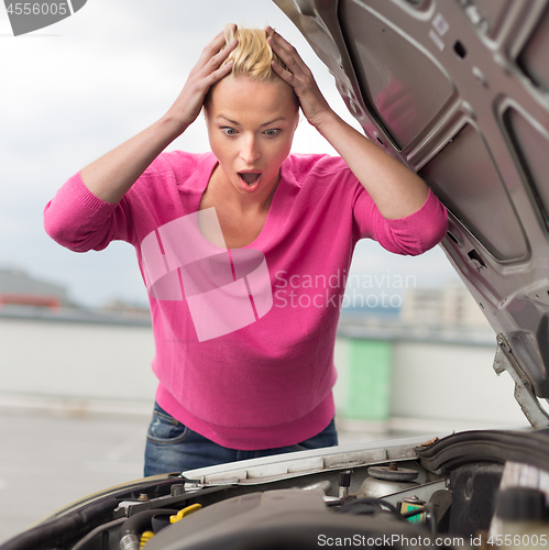 Image of Stressed Young Woman with Car Defect.