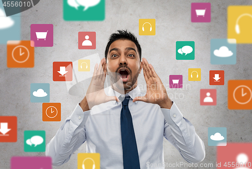 Image of indian businessman shouting over app icons