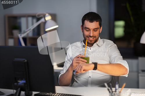 Image of happy businessman with smart watch at nigh office