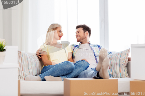 Image of happy couple with boxes moving to new home