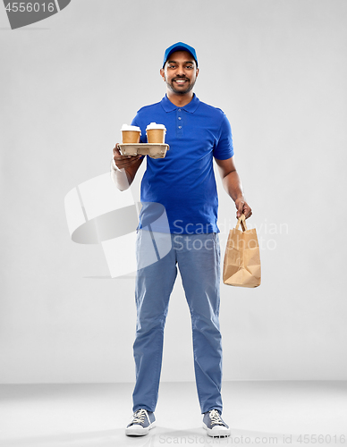 Image of happy indian delivery man with food and drinks