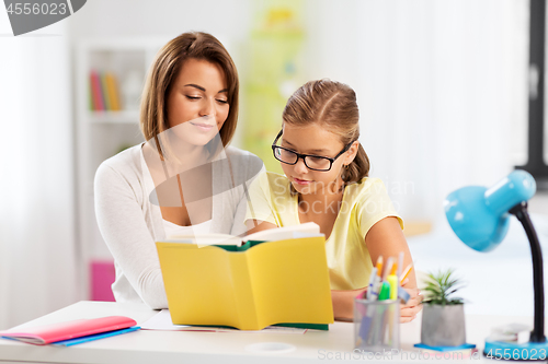 Image of mother and daughter doing homework together