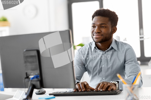 Image of african businessman with computer at office