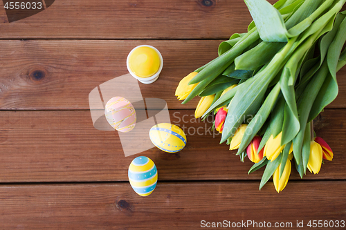 Image of colored easter eggs and tulip flowers