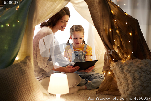 Image of family with tablet pc in kids tent at home