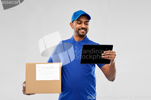 Image of indian delivery man with tablet pc and parcel box